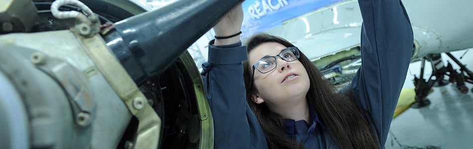 female aerospace engineer looking at a part